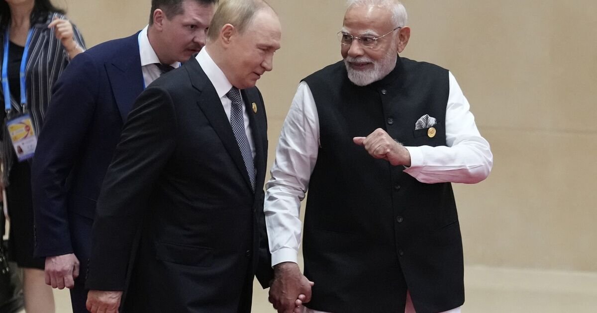 Moment-Putin-holds-hands-with-Indian-PM-Modi-at-anti-NATO.jpg