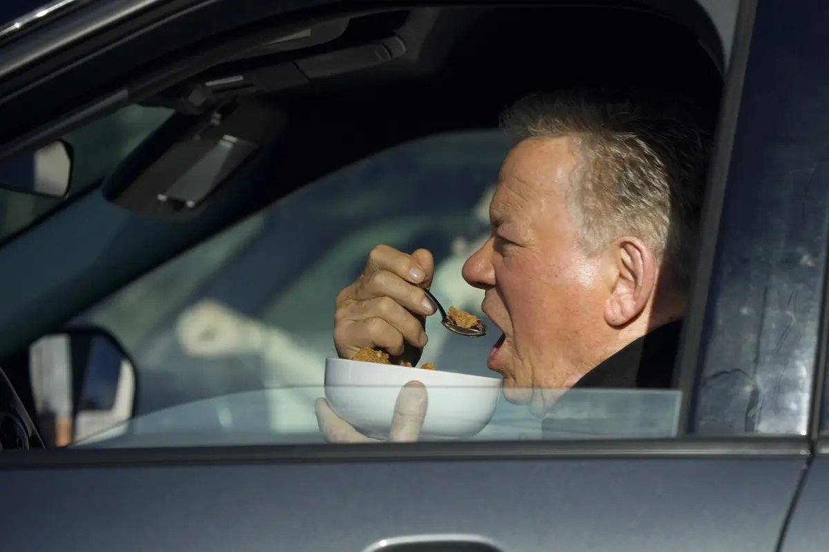 William Shatner boldly devours cereal while driving his SUV in Studio City