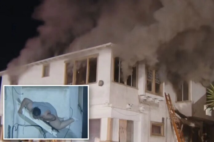 Terrifying-moment-woman-jumps-from-2nd-floor-window-as-building-erupts.jpg